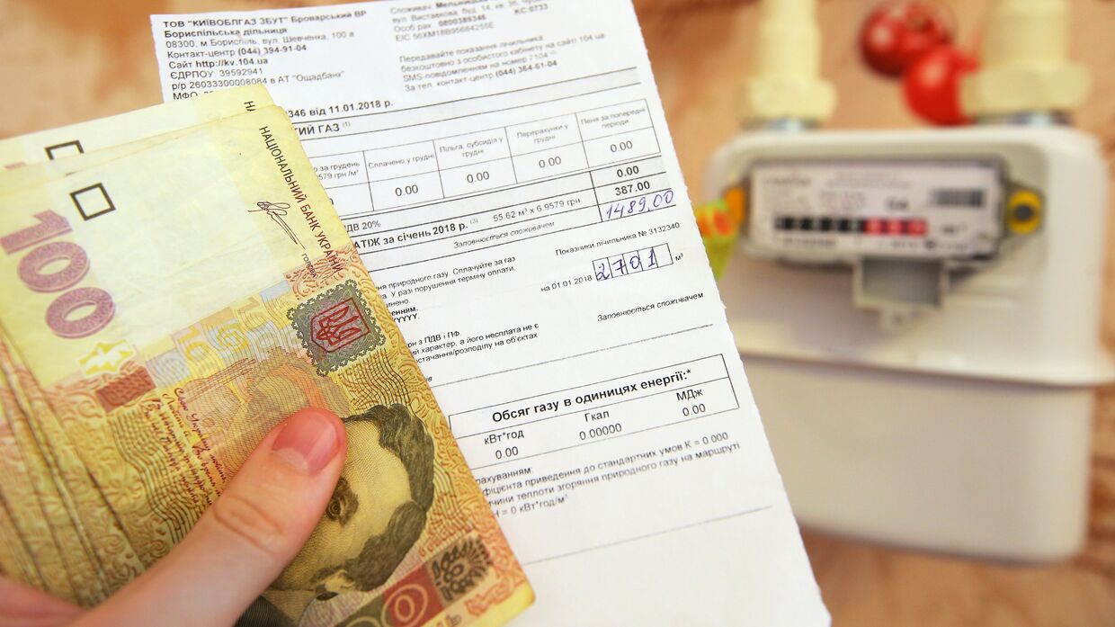Денежные купюры Украины и квитанция за оплату коммунальных услуг